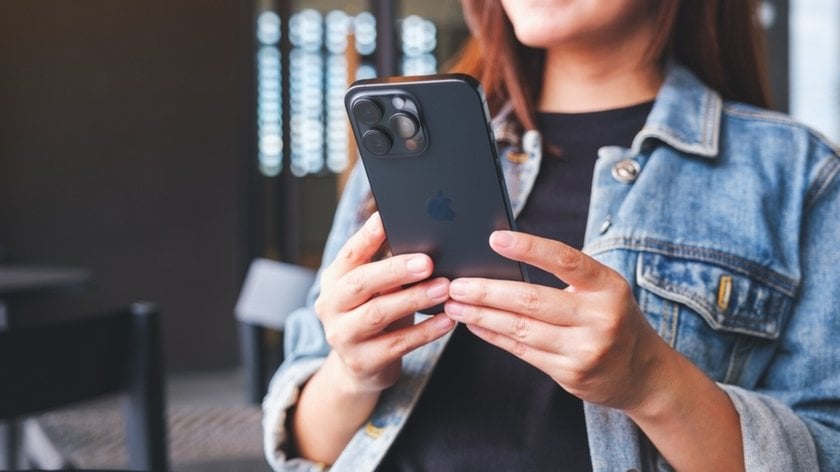 A girl holds an iPhone in her hands | Skylum Blog