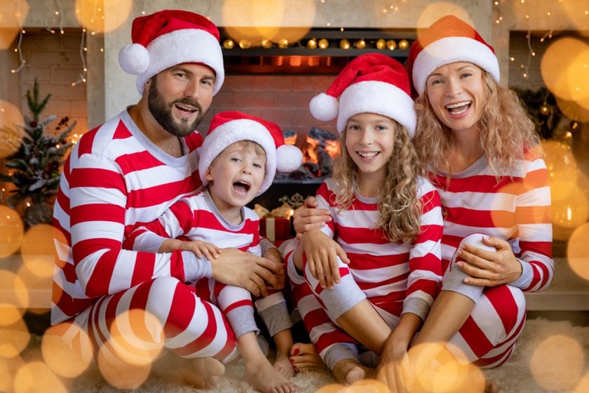 A family photo in matching pajamas and Santa hats | Skylum Blog