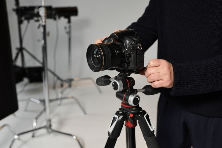 A photographer adjusts his camera | Skylum Blog