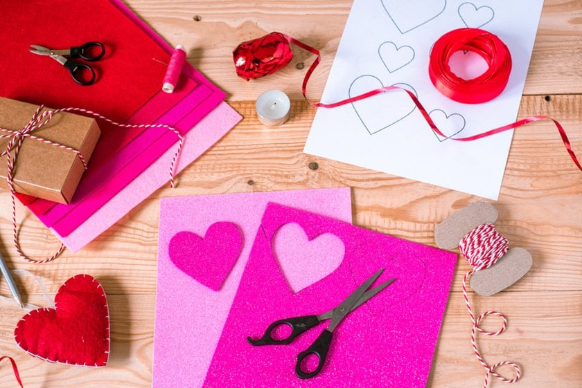 Pink paper hearts and scissors on a wooden table | Skylum Blog