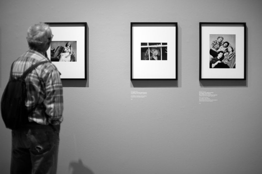 A man looks at a photo in a gallery | Skylum Blog