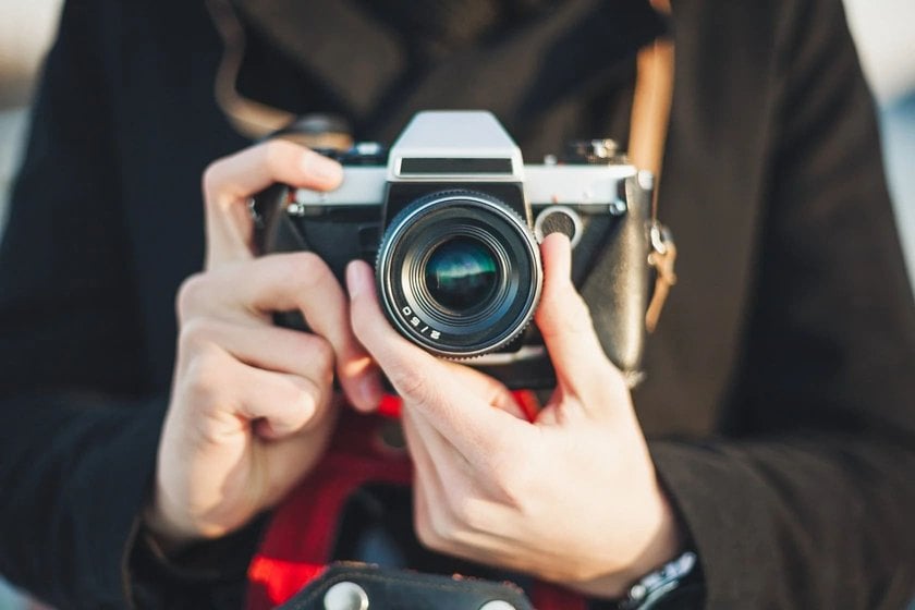 Girl with a Camera Adjusting the Lens | Skylum Blog