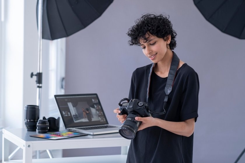 A photographer looks at a photo in a camera | Skylum Blog